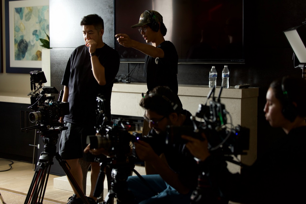 More Than Vision team coordinating a shoot beside cameras and lighting equipment